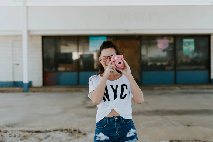 Smiling content creator holding a camera