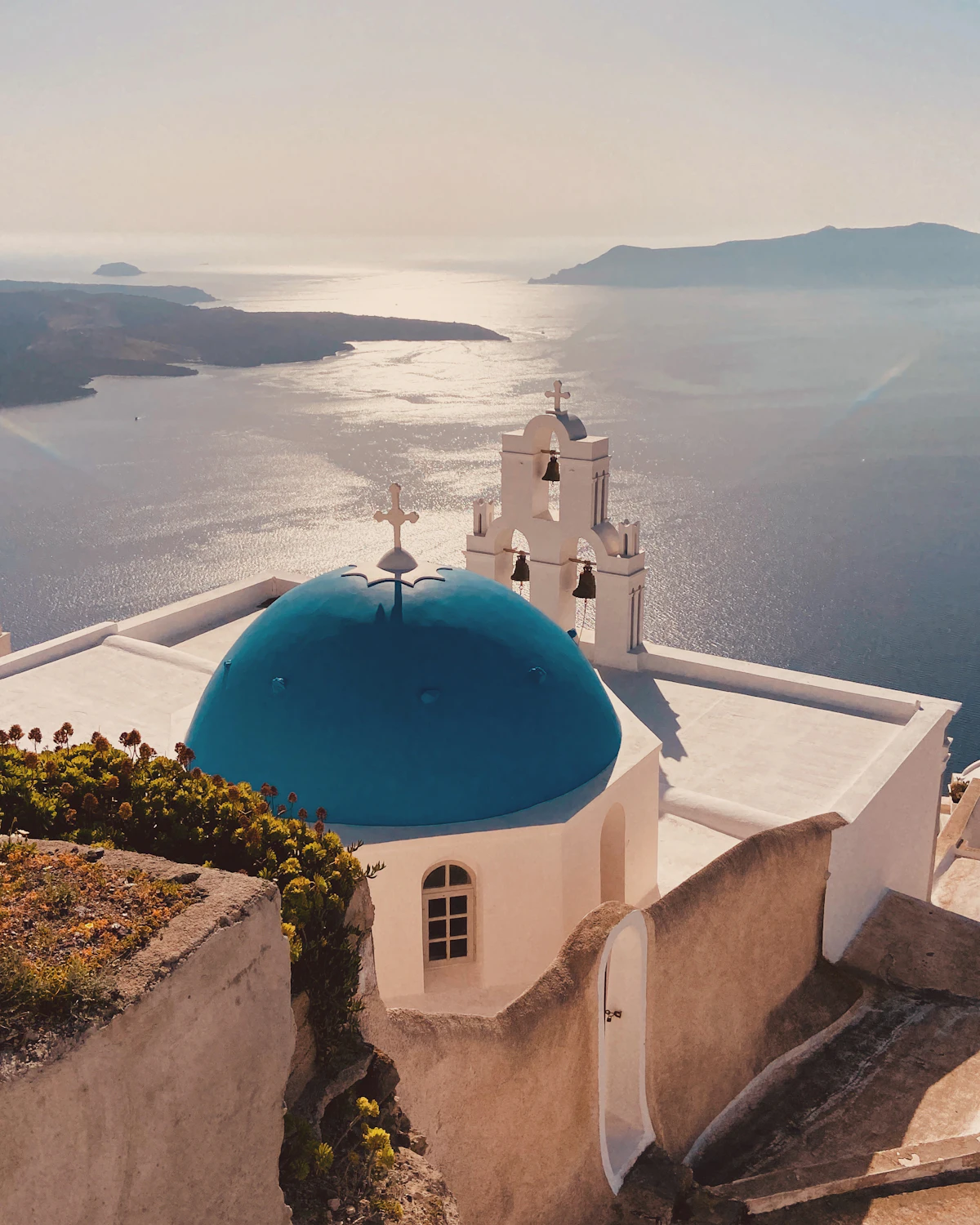 Blue-domed church overlooking the Aegean Sea in Santorini, Greece